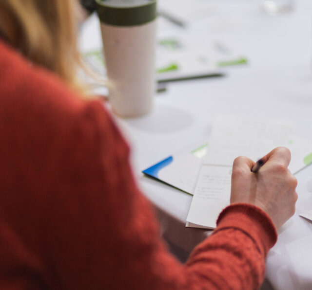 Photo of a person writing on a piece of paper