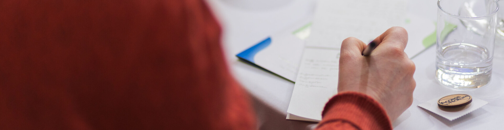 Photo of a person writing on a piece of paper