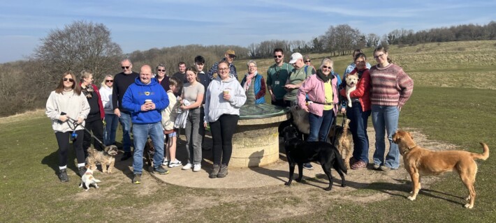 A photo of a Sunflowers Suicide Support walking group out on a countryside walk with their dogs.
