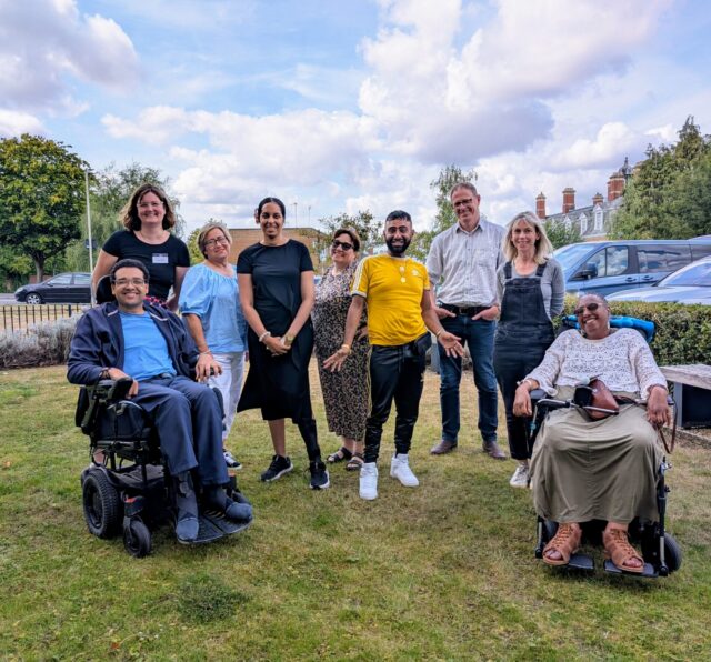 A group of Barnwood Trust and Barnwood Circle members a part of the Anti Racism Engagement Group outside of Barnwood Trust's office smiling.